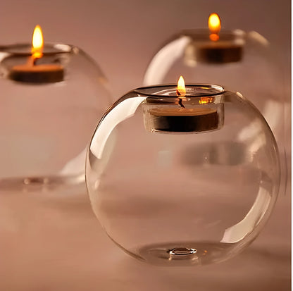 Handmade hollow round glass candle holder in European style on a table.