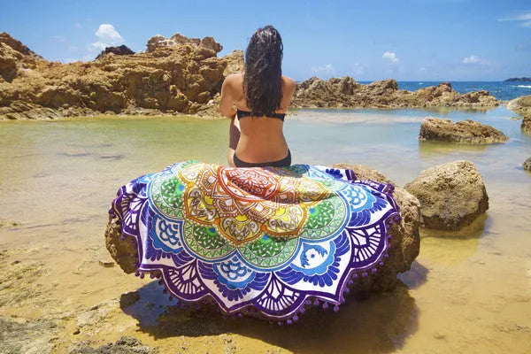 Round floor mat with polygon print and tassel trim, shown in available colours.