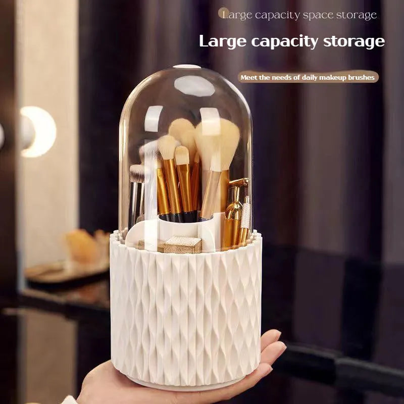 White rotating acrylic makeup brush holder with transparent dustproof lid on a desktop.