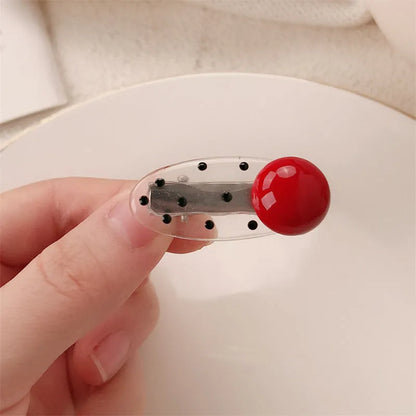 Red love heart-shaped hair barrette clip with retro white dots on a willow leaf-shaped base.
