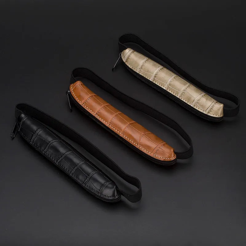 Long beige grey PU leather pencil case on a desk with pens