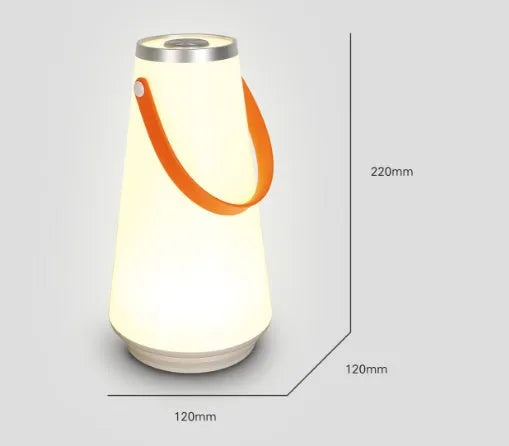 White rechargeable LED lantern with USB cable on a bedside table.