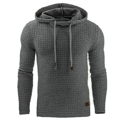 A man wearing a cotton-polyester blend hoodie available in nine colours including black, navy, and red.