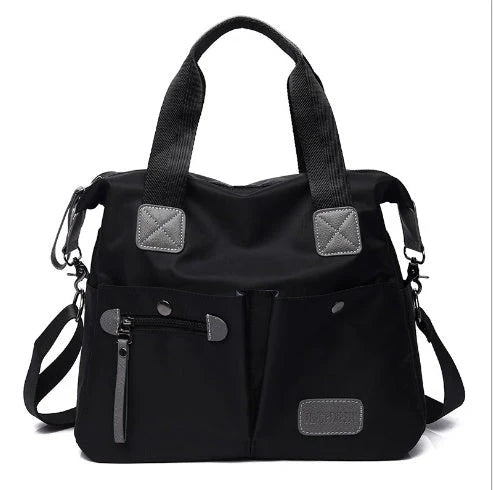 A fashionable and versatile ladies tote bag with multiple compartments and carrying options for the modern woman on the move.