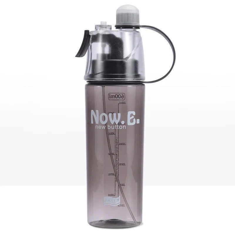 Green mist spray sports water bottle with handle, scale, and press-top lid on a gym bench.