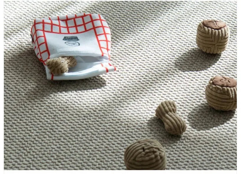 Dog sniffing toy set with two walnut pieces, one peanut piece and snack bag with rustling paper