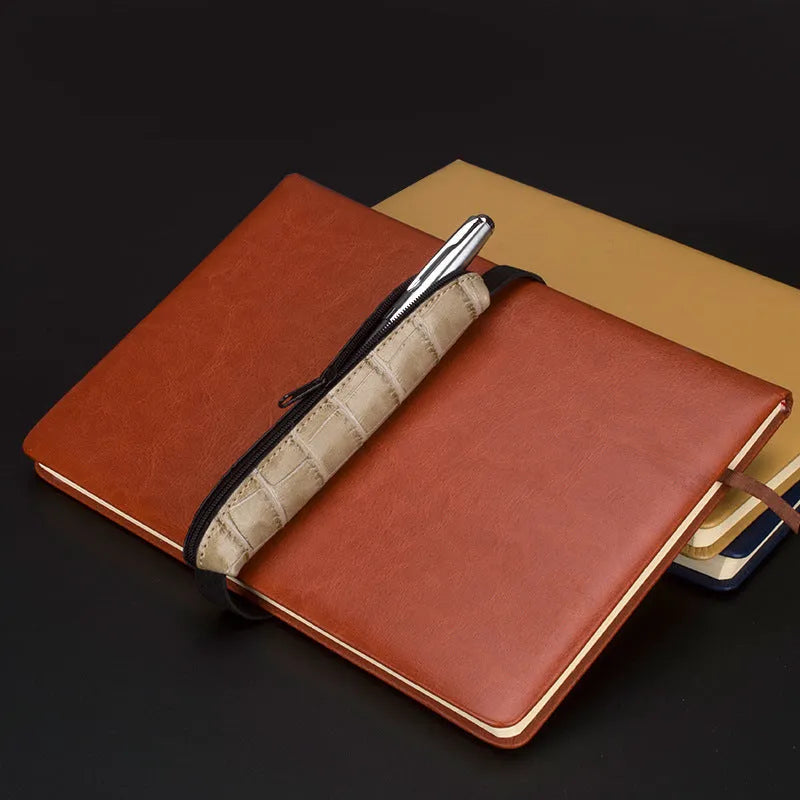 Long beige grey PU leather pencil case on a desk with pens