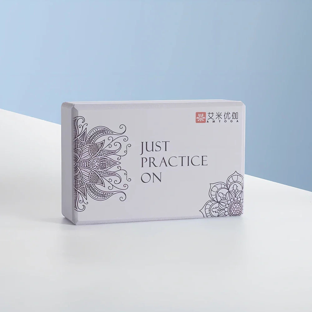 Black yoga brick with mandala pattern, 23cm long with textured surface for secure grip during yoga practice