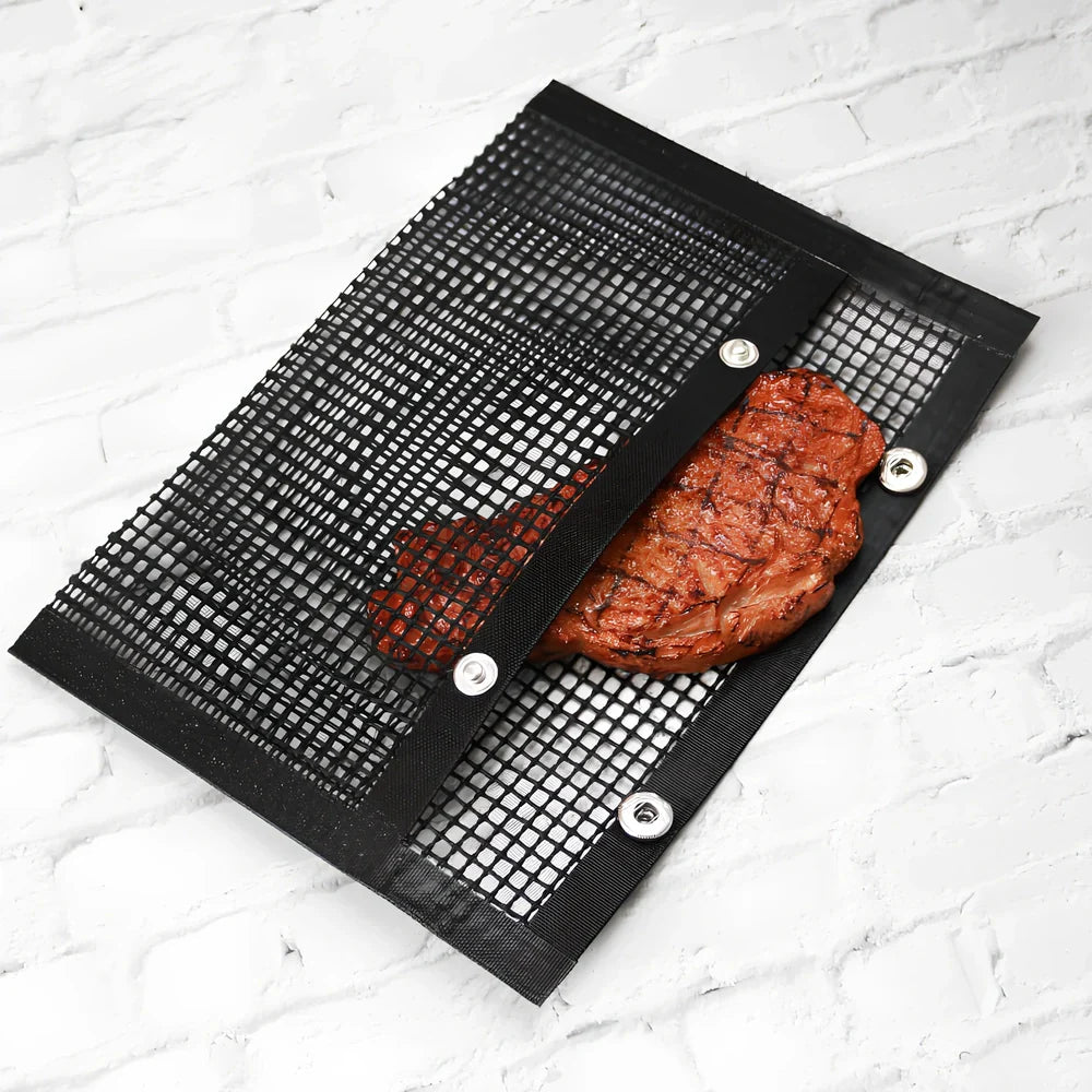 Black grill mesh bag with non-stick grid mat for BBQ cooking showing smoke-through design