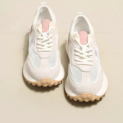 Women's grey low-top retro sneakers with mesh lining and round toe on a flat rubber sole.