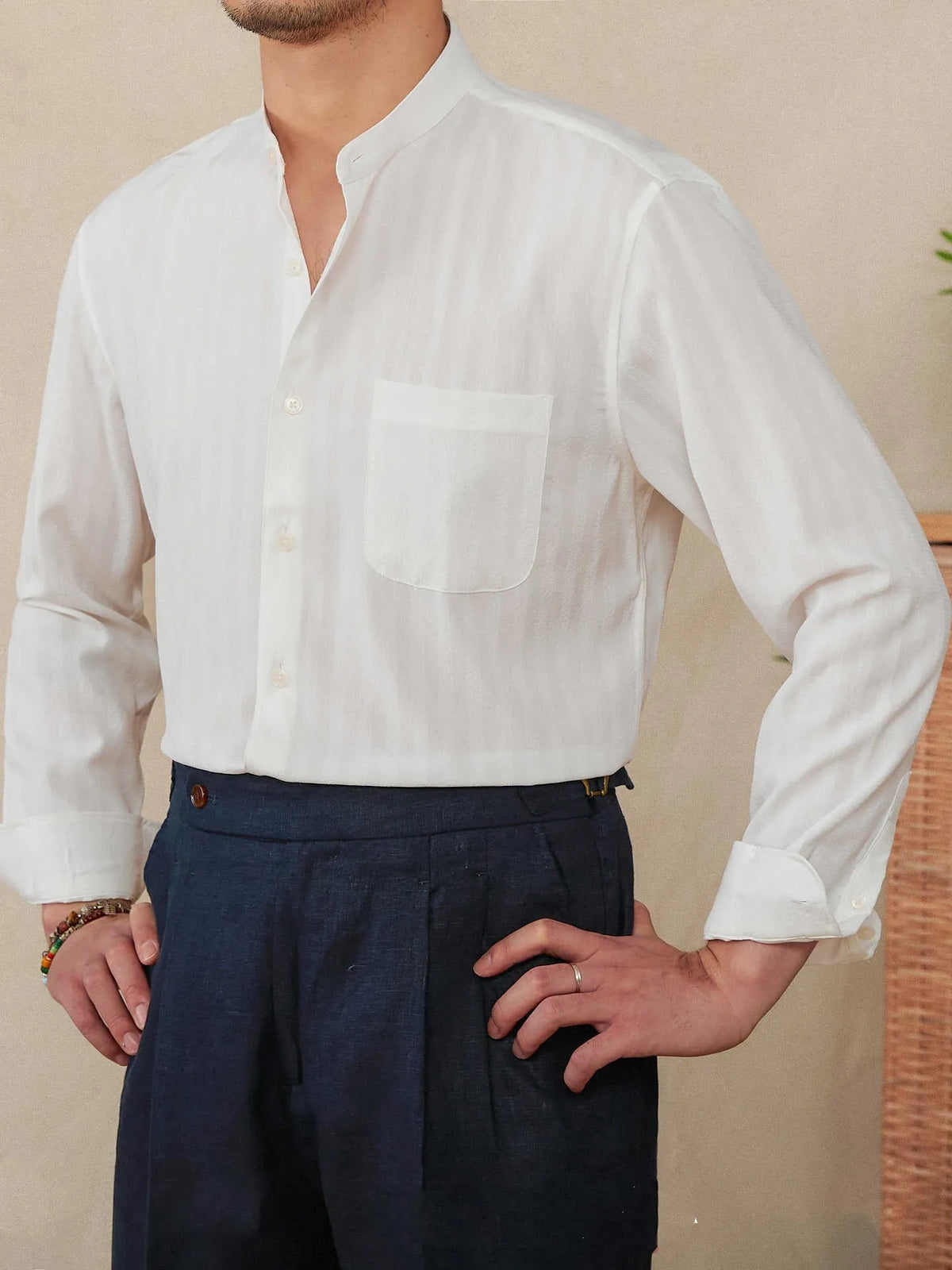 Blue and white seersucker striped long sleeve shirt with a loose lapel baseball collar.