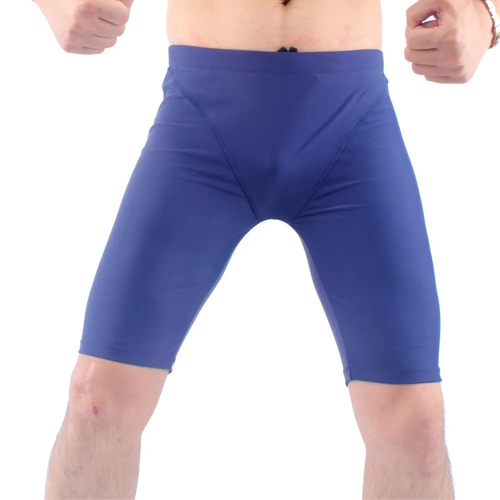 Men's green and navy blue quick-dry swimming trunks with loose fit and anti-embarrassment design