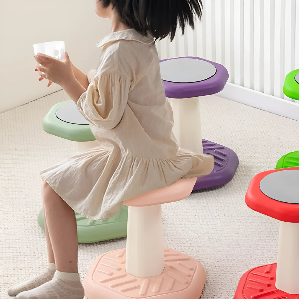 Balance children's plastic rocking stool in blue colour on a wooden floor.
