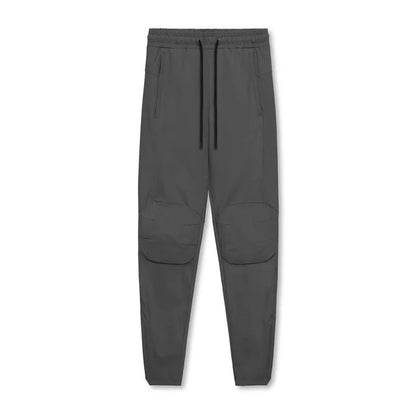 Men's grey fitness trousers with ankle ties, made from 100% polyester for quick-drying during exercise