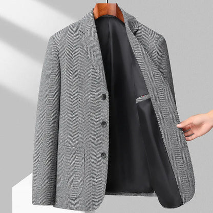 Man wearing a simple, loose-fit solid-colour casual coat in a neutral shade.