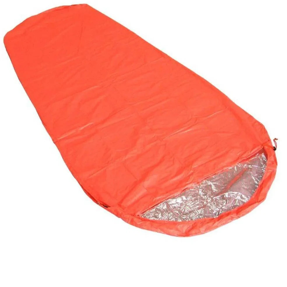 Orange outdoor thermal sleeping bag with silver coated nylon showing envelope design and storage bag