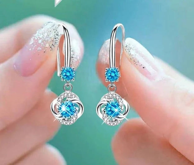 Silver stud earrings with four-leaf clover design and fairy ear hooks