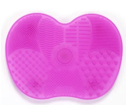 Silicone makeup brush cleaning pad, 15.5 x 12 cm, shown as a coloured brush cleaner mat for cleansing makeup brushes.