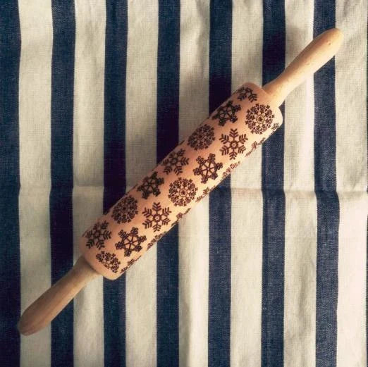 Festive rolling pin with embossed Christmas designs for easy imprinting on dough