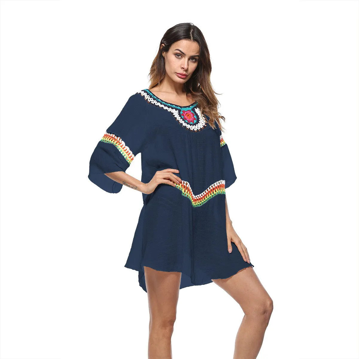 Crocheted white beach cover-up with open-knit design, worn over swimsuit, demonstrating UPF 50+ sun protection.