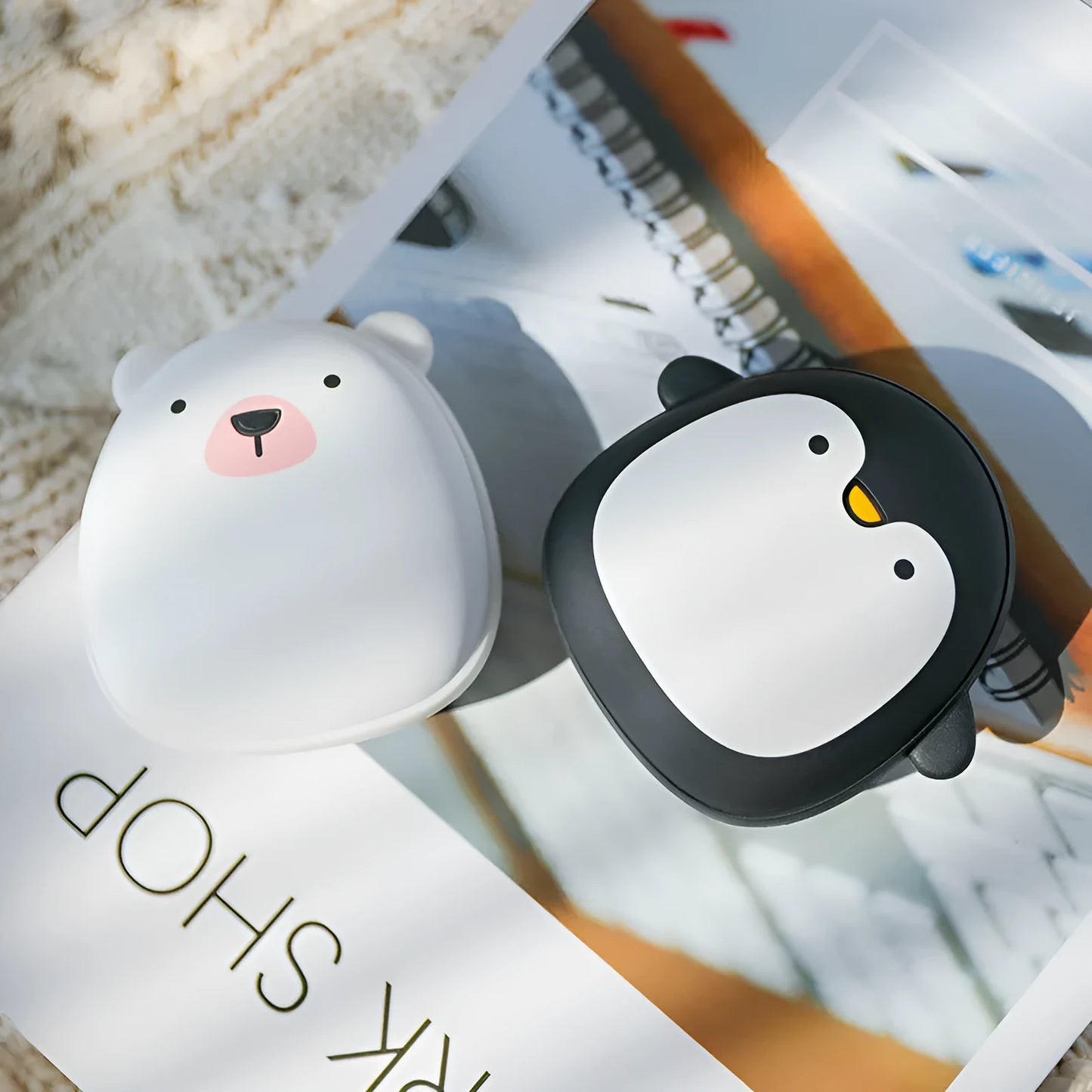 Cute cartoon penguin and polar bear design USB rechargeable hand warmer and power bank unit.