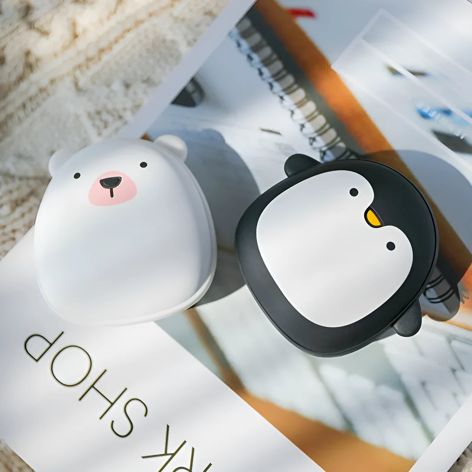 Cute cartoon penguin and polar bear design USB rechargeable hand warmer and power bank unit.