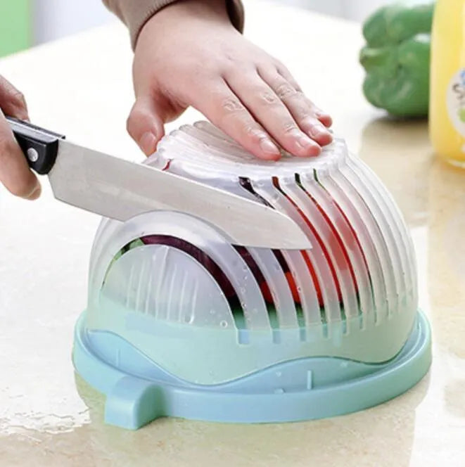 Blue salad cutter bowl showing cutting lid with seams, drain basket function, and reversible base plate