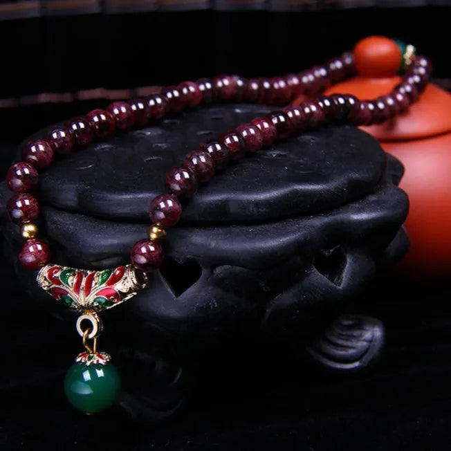 Natural garnet bracelet with 7mm stones, double ring design and golden toad charm