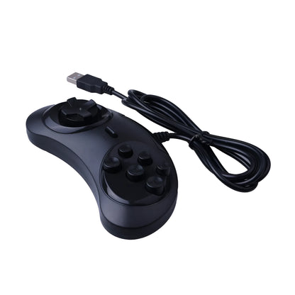 Black Sega USB PC game controller with 1.8m cable on a desk next to a laptop