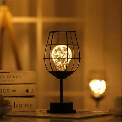 Minimalist wrought iron table lamp shaped like wine bottle with warm white LED light
