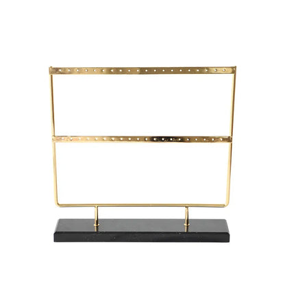 Alloy earring storage rack in green or white, holding earrings on a dresser or display counter.