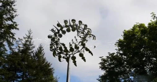 Elegant stainless steel outdoor windmill spinner with dual-layered blades rotating in opposite directions, creating a mesmerising display in the garden