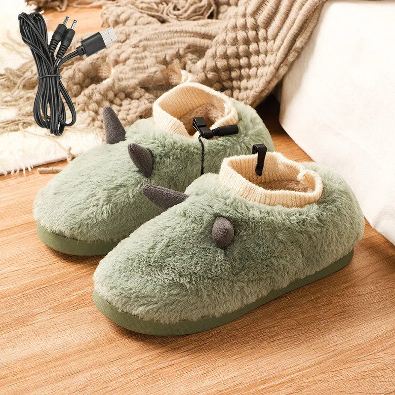 USB heating slippers in black plugged into a laptop, showing the cable and soft velvet upper.