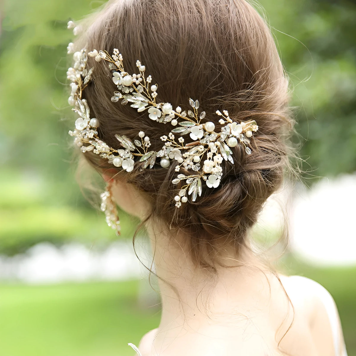 Gold bridal hair clip 27 x 13cm and earrings 6.5 x 4cm with rhinestone, crystal and imitation pearl details.
