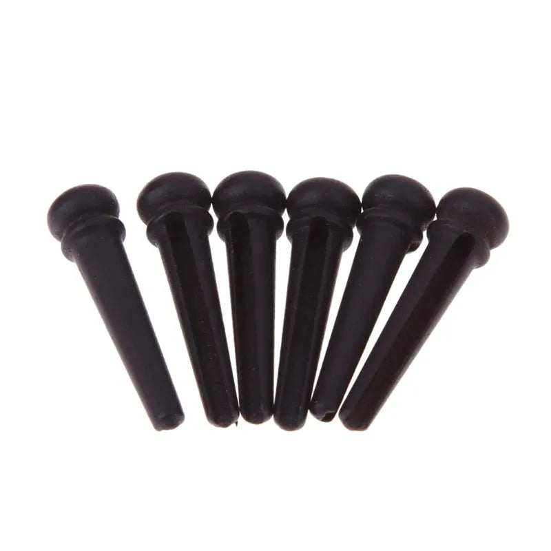 Six ebony folk guitar string nails with matte black finish and 5.3mm bayonet diameter