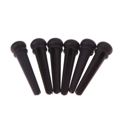 Six ebony folk guitar string nails with matte black finish and 5.3mm bayonet diameter