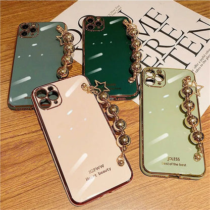 Electroplated bead wrist strap bracelet case for iPhone in light green, pink, and dark green, TPU back cover.