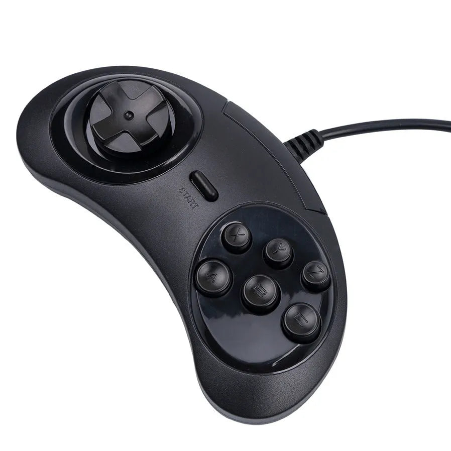 Black Sega USB PC game controller with 1.8m cable on a desk next to a laptop