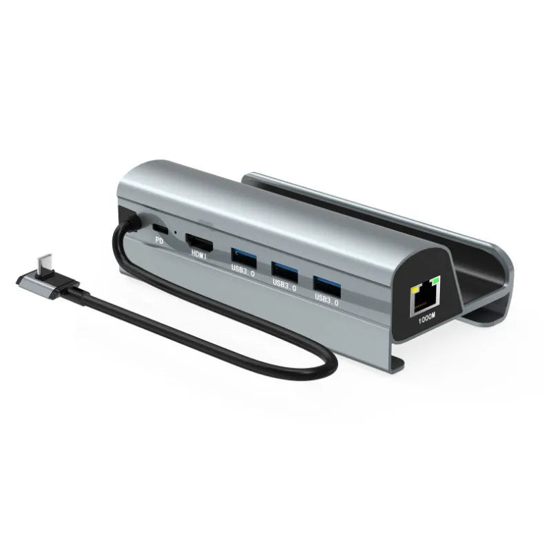 GPD WIN4 handheld game console sitting in a black docking base expander showing multiple ports on the front.
