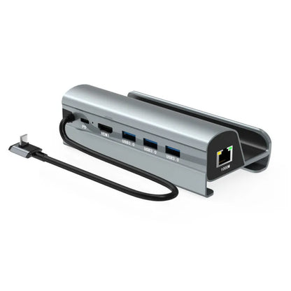 GPD WIN4 handheld game console sitting in a black docking base expander showing multiple ports on the front.