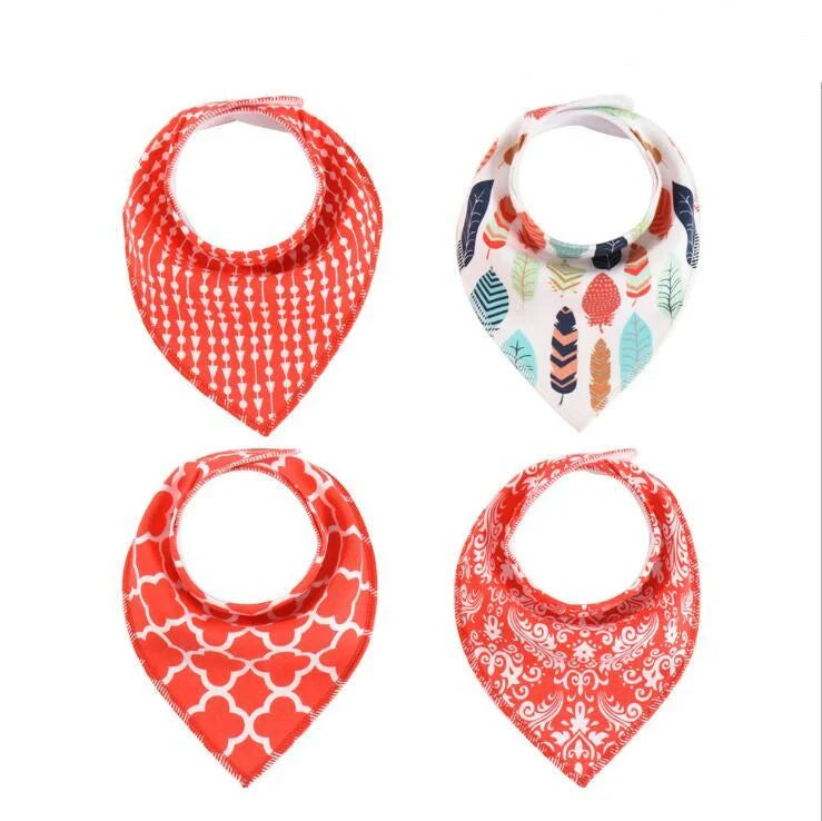 Set of four cotton baby bibs with arrow and wave designs for mess-free feeding
