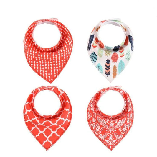 Set of four cotton baby bibs with arrow and wave designs for mess-free feeding