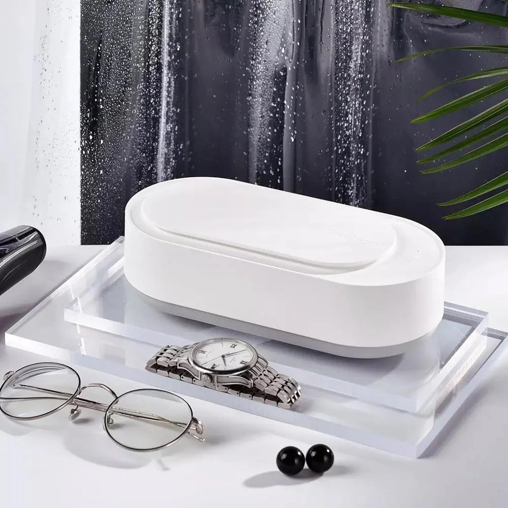 White portable ultrasonic cleaner with stainless steel tank for cleaning jewellery and glasses.