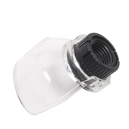 Transparent horn-shaped safety cover for a Delta angle grinder on a workshop bench.