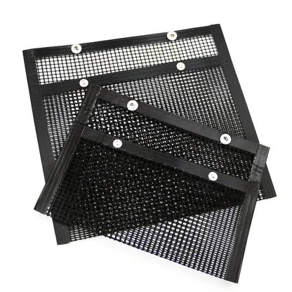 Black grill mesh bag with non-stick grid mat for BBQ cooking showing smoke-through design