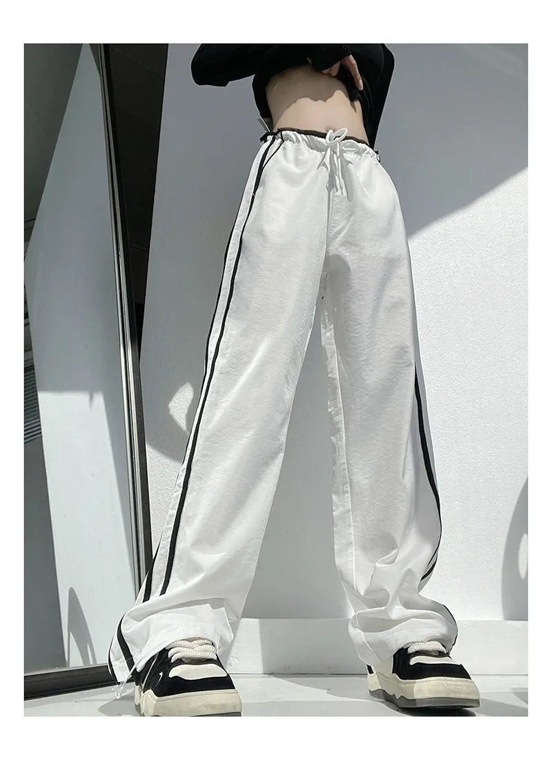 Women's navy blue straight-leg trousers with white contrast ribbon parallel bars pattern design