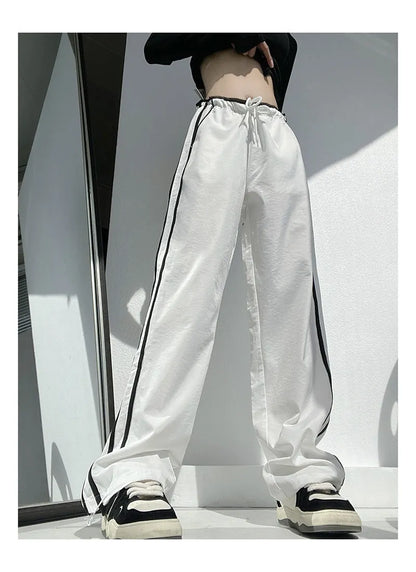 Women's navy blue straight-leg trousers with white contrast ribbon parallel bars pattern design