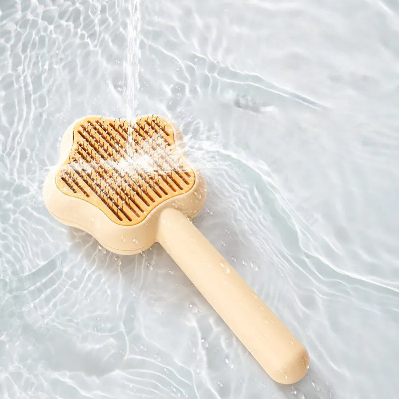 Green and yellow stainless steel self-cleaning cat comb for de-shedding, measuring 20cm.