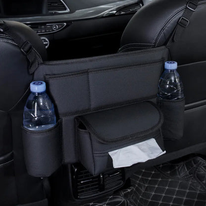 Black leather car seat gap storage bag hanging from armrest with tissue box, showing textured grain detail.