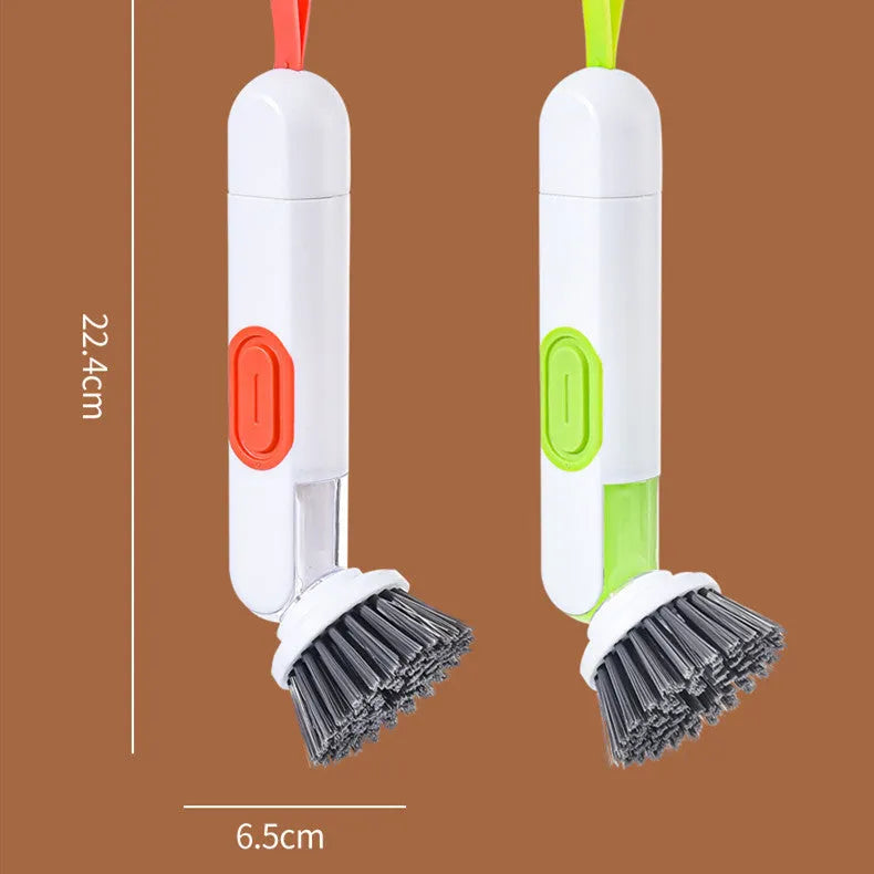 White and red long-handle kitchen brush with soap dispenser button and two interchangeable scrub heads on a hook.